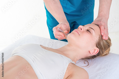 spa beauty treatment and skincare. Woman getting facial massage by beautician at spa salon, close-up
