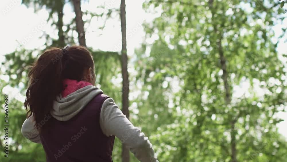 attractive girl Jogging. athlete joyfully lifts his hands in the end of the workout. slow motion attractive girl Jogging. athlete joyfully lifts his hands in the end of the workout. slow motion