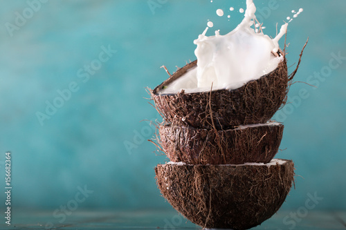 Coconut and coconut vegan milk non dairy on blue background with copy space photo