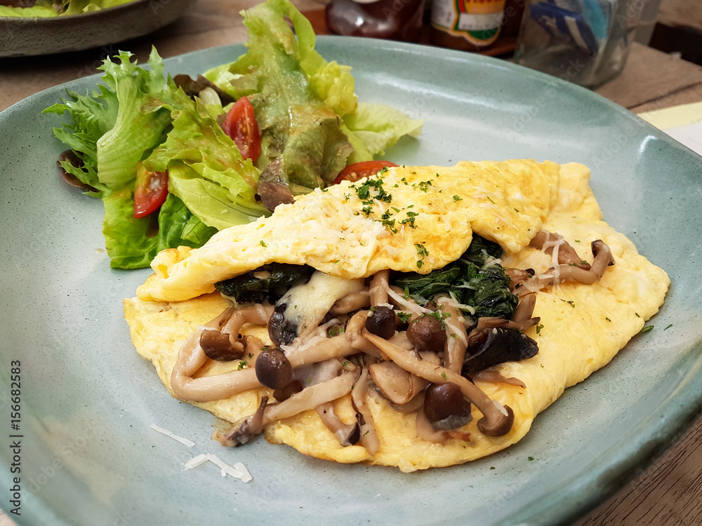 Close-up Omelet with Spinach and Mushroom Served with Salad