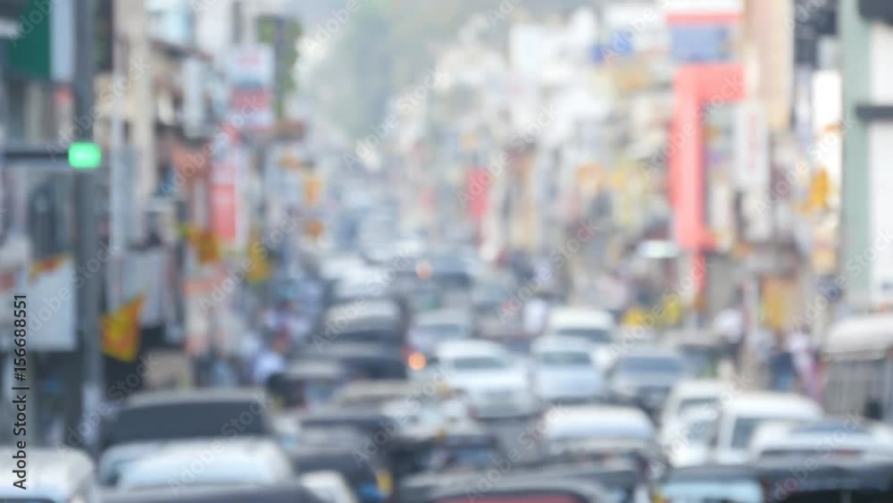 Blurred unrecognizable people are walking around city center. Cars drive on roads in the town. Out of focus is backdrop of bustling big city with busy traffic Blurred unrecognizable people are walking around city center. Cars drive on roads in the town. Out of focus is backdrop of bustling big city with busy traffic