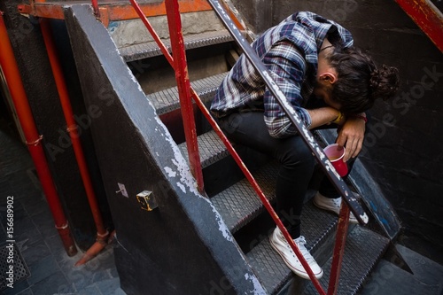 Drunk man sitting on staircase photo