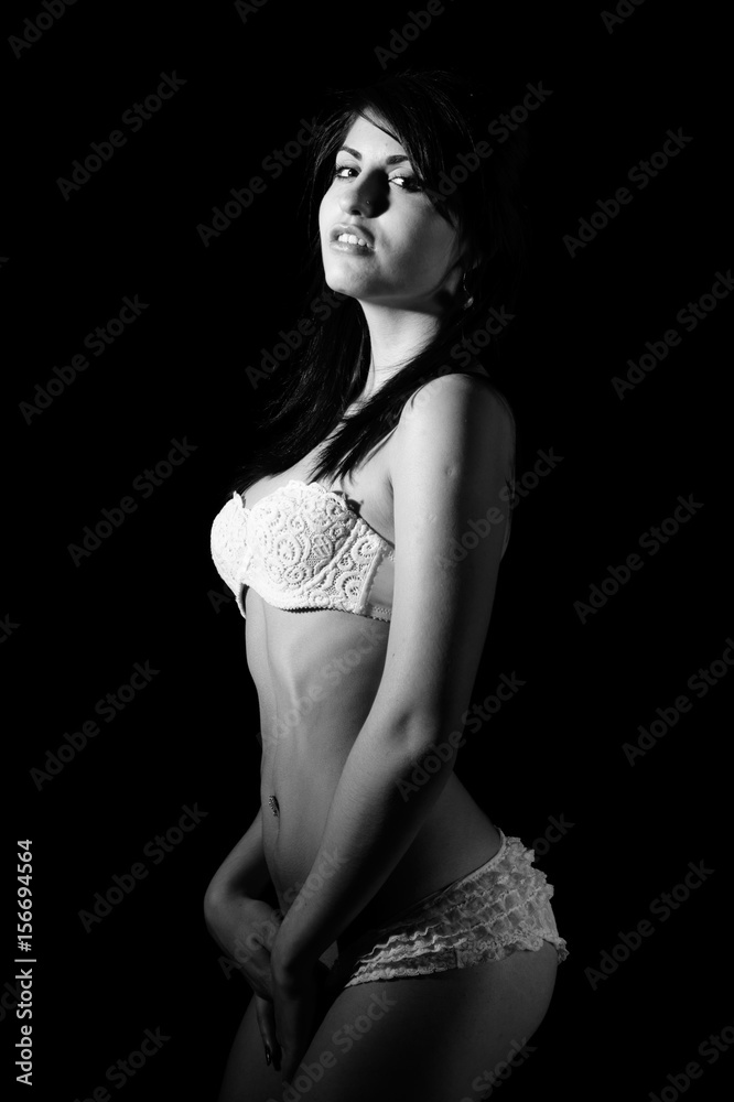 black and white or monochrome portrait of young beautiful sensual woman with perfect sexy slim body sexually posing in white lingerie keeping her hands at pussy Stock Photo Adobe Stock