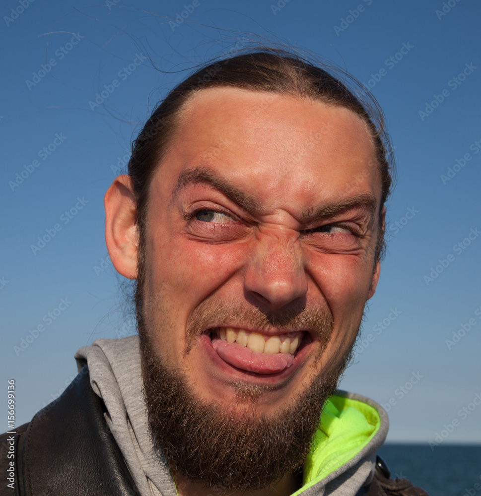 Young man made ugly face. Stock Photo | Adobe Stock