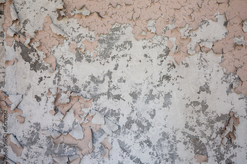 pink peeling paint on concrete wall texture 