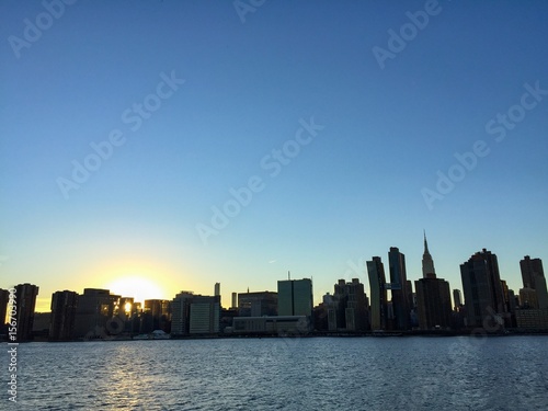 Silhouette of buildings in Manhattan with sunset and river  New York