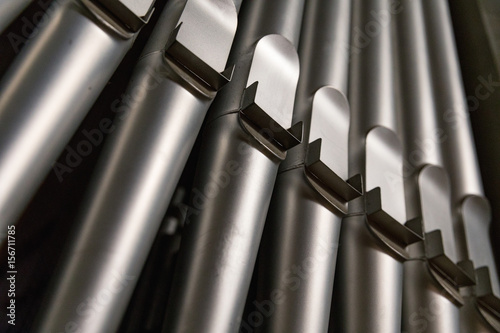 part of the church organ with many air pipes made of metal photo