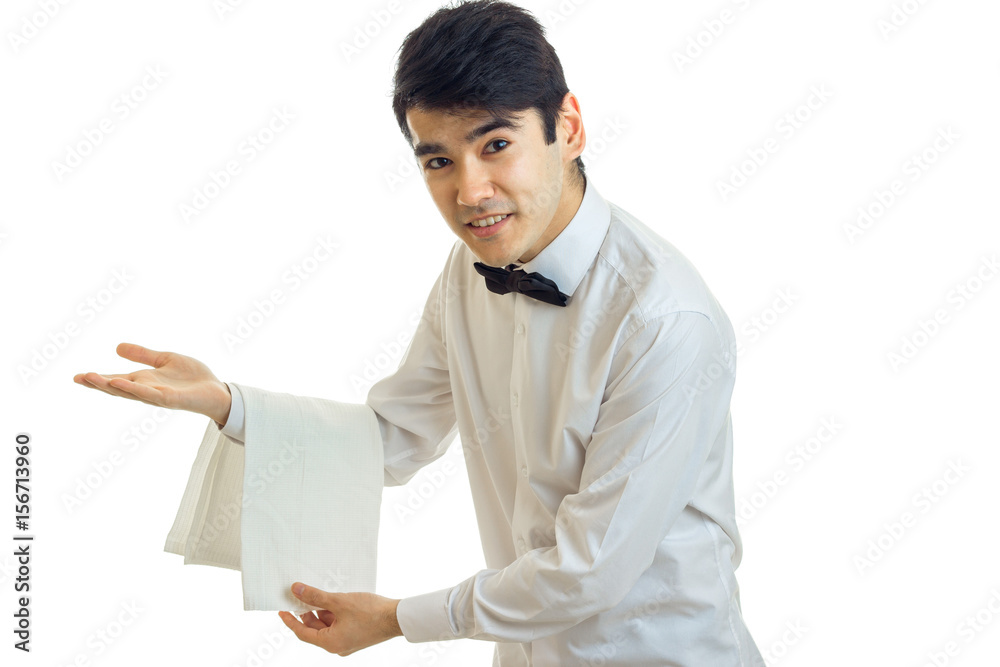 handsome young waiter invites guests to the table and smiling handsome young waiter invites guests to the table and smiling