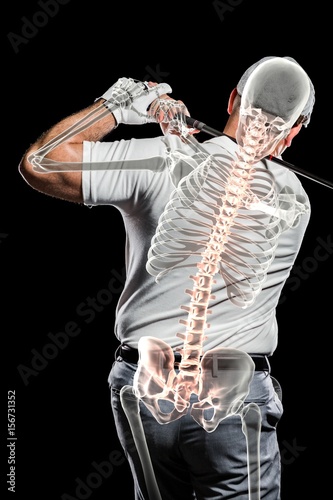 Golfer practicing against black background