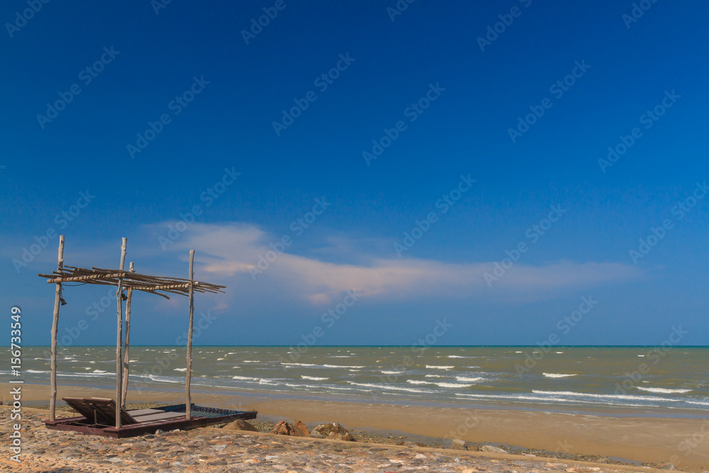 a shad put on the beautiful beach and clear blue sky with copy space, background for holiday travel or relax a shad put on the beautiful beach and clear blue sky with copy space, background for holiday travel or relax