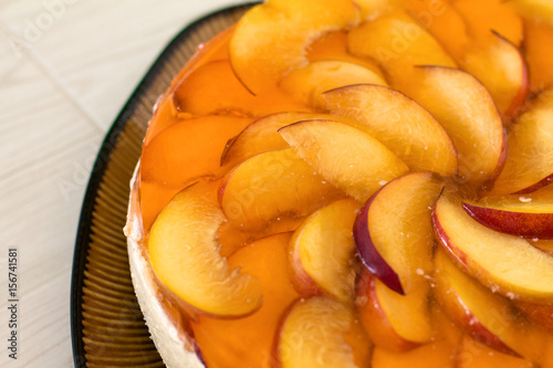 Wallpaper Mural Fruit cake with peach, jelly and mousse in plate on wooden background. Torontodigital.ca