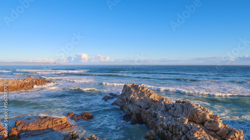 Rocks at Sea with Waves and Clouds