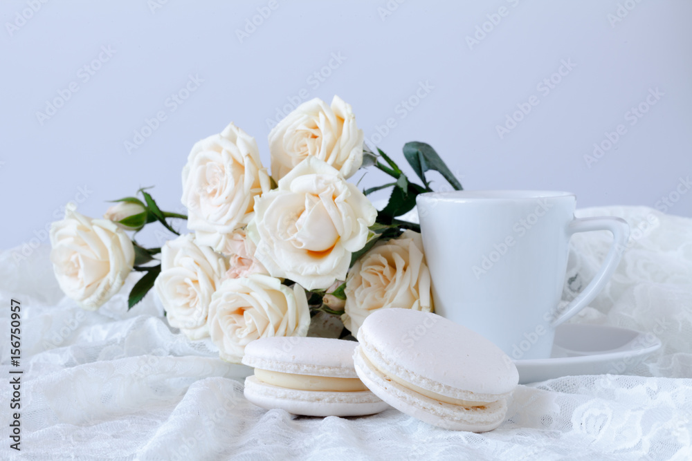 cup of coffee and a bouquet of white roses cup of coffee and a bouquet of white roses