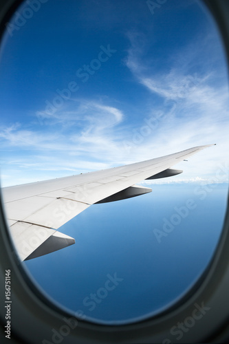 plane window high on the blue skies
