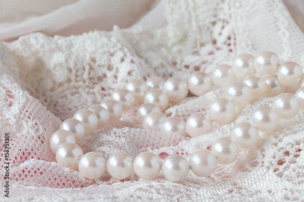 Background of white delicate lace fabric and pearls Background of white delicate lace fabric and pearls