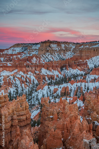 Pink Clouds Above Byce Point with lingering snow over hoodoos