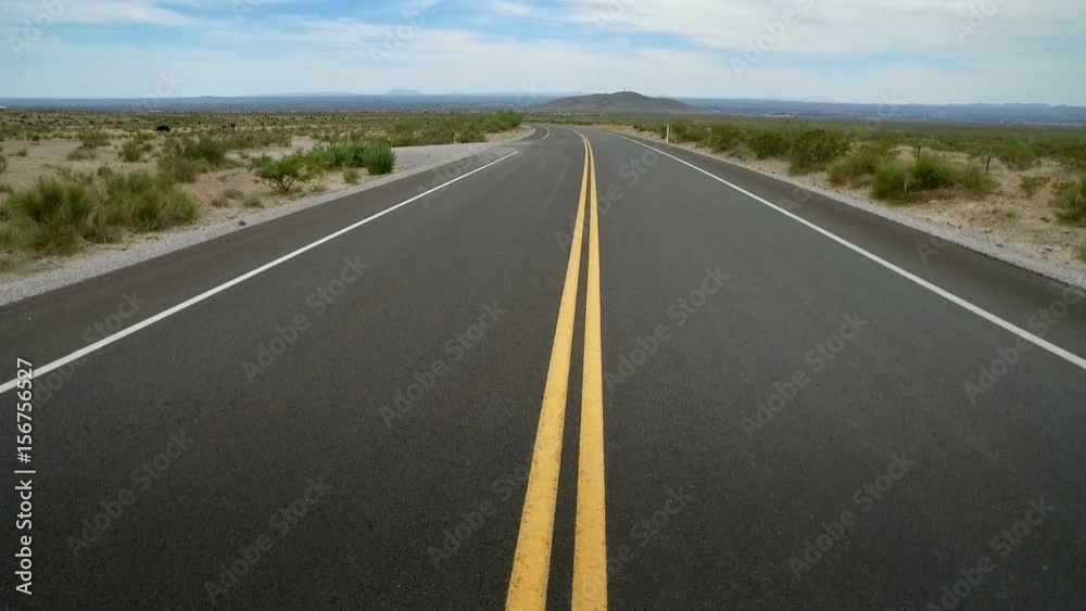 Empty Desert Road Middle During Daytime. view moving up the middle of a highway road in the desert during daytime. Slow motion
Empty Desert Road Middle During Daytime. view moving up the middle of a highway road in the desert during daytime. Slow motion