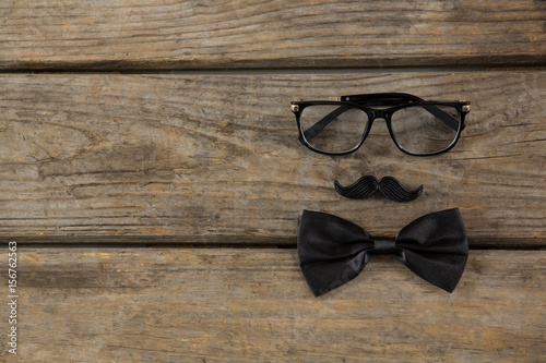Overhead view of bow tie with mustache and eyeglasses