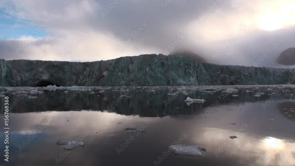 Glacier on the coast in the background of water of Arctic Ocean in Svalbard. Wildlife in Nordic badlands. Unique footage on background natural landscape and snow of Spitsbergen. Glacier on the coast in the background of water of Arctic Ocean in Svalbard. Wildlife in Nordic badlands. Unique footage on background natural landscape and snow of Spitsbergen.