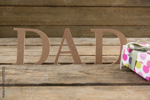 Dad text by gift box on table