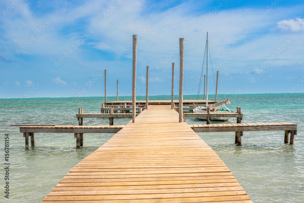 Wooden pier dock and ocean view at Caye Caulker Belize Caribbean.
