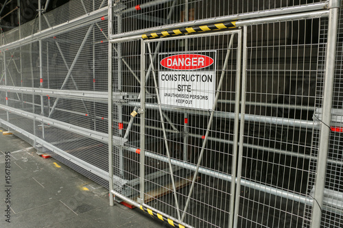 A red, black and white ‘Danger - Construction Site’ warning sign