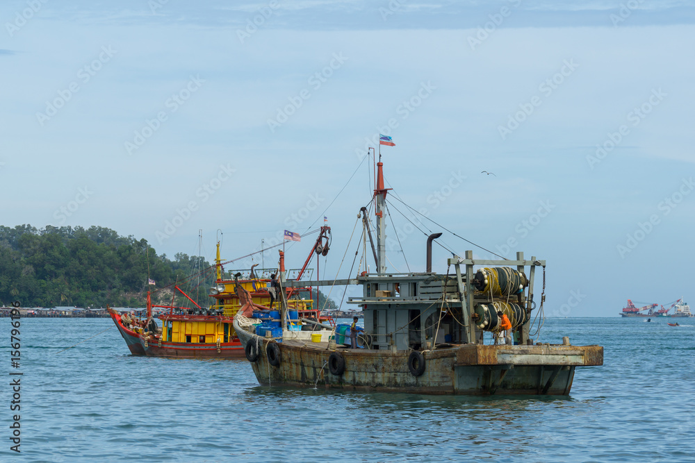 Fisherman boats anchored at Kota Kinabalu (KK). KK is a major city with unquestionably some of the best beaches on the Borneo island. - obrazy, fototapety, plakaty 