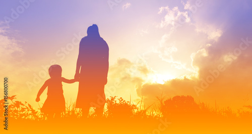 silhouettes of a women with her kid during sunset