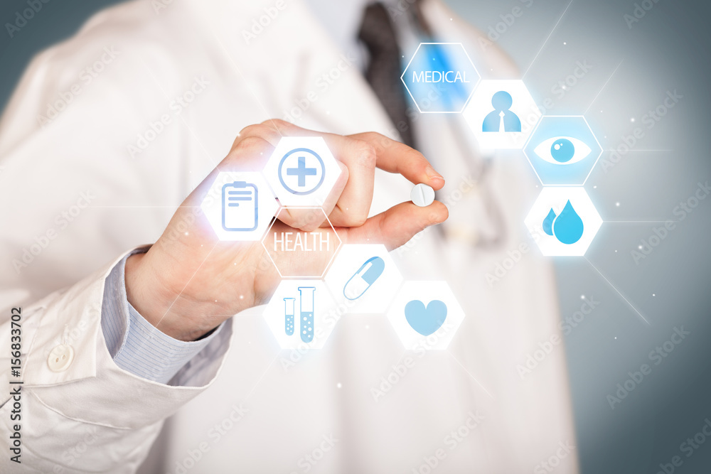 A doctor in white holding a pill A doctor in white holding a pill