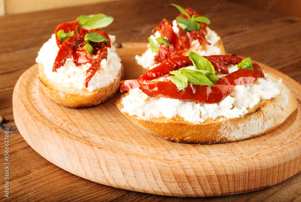 Italian sandwiches - bruschetta with cheese, tomato and basil Italian sandwiches - bruschetta with cheese, tomato and basil