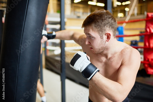 Young man training in mix-fight club