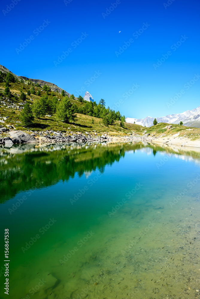 Gruensee (Green lake) with view to Matterhorn mountain - trekking in the mountains near Zermatt in Switzerland