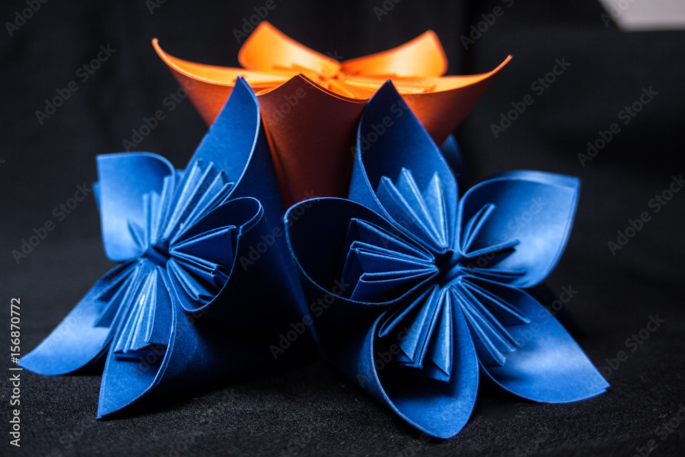 Fototapeta premium Origami flower on black background