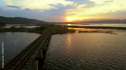 Wallpaper Mural Aerial reveal of a railway bridge with the sun reflecting off the water. Torontodigital.ca