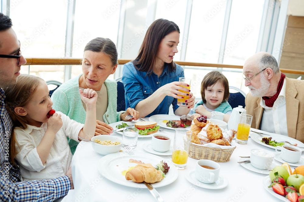 Big family of three generations having breakfast in restaurant