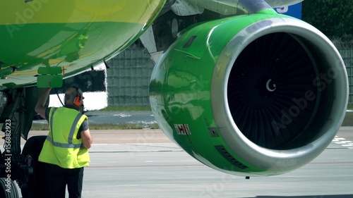 Commercial airliner being checked before the flight by the airport personnel