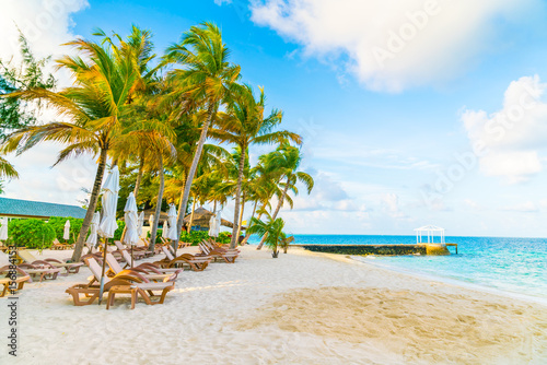Beach chairs with umbrella at Maldives island  white sandy beach and sea .