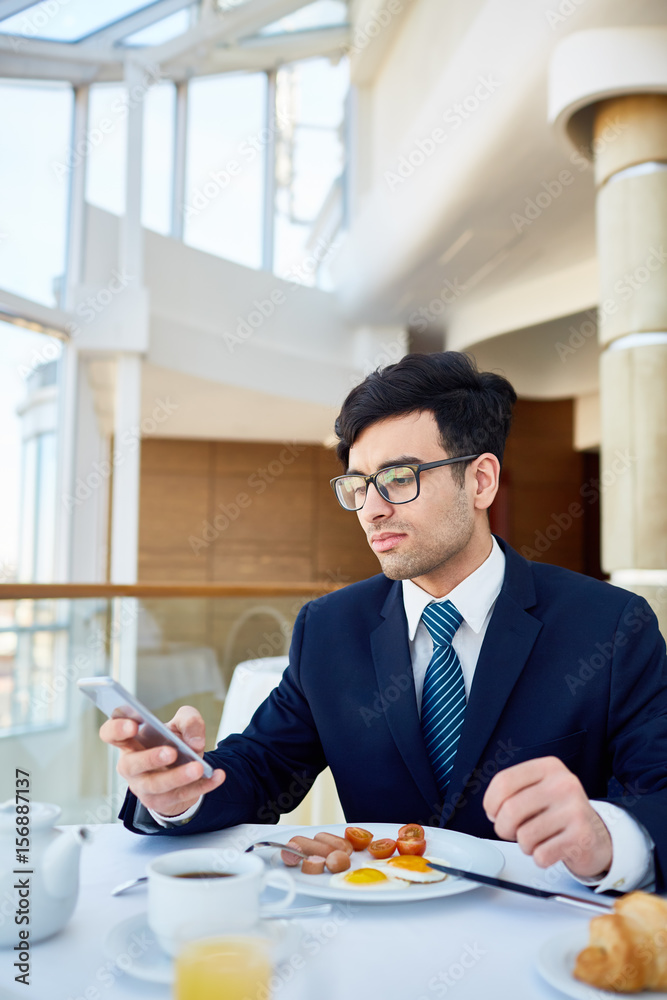 Busy leader texting in smartphone at lunch break Busy leader texting in smartphone at lunch break