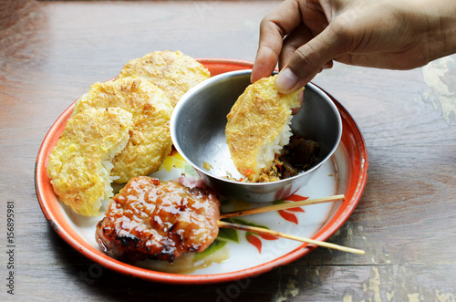 Delicious Khao Jee Sticky rice with egg and grilled pork and spicy suace for Thai e-saan local foods backgrounds photo