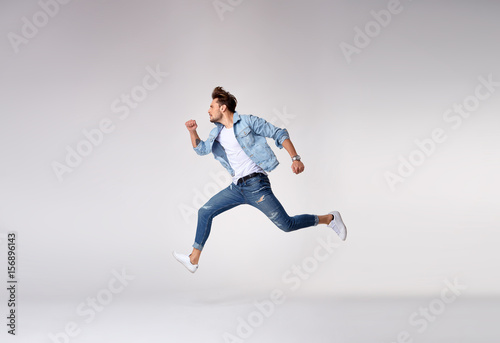 Stylish, handsome man running - isolated photo