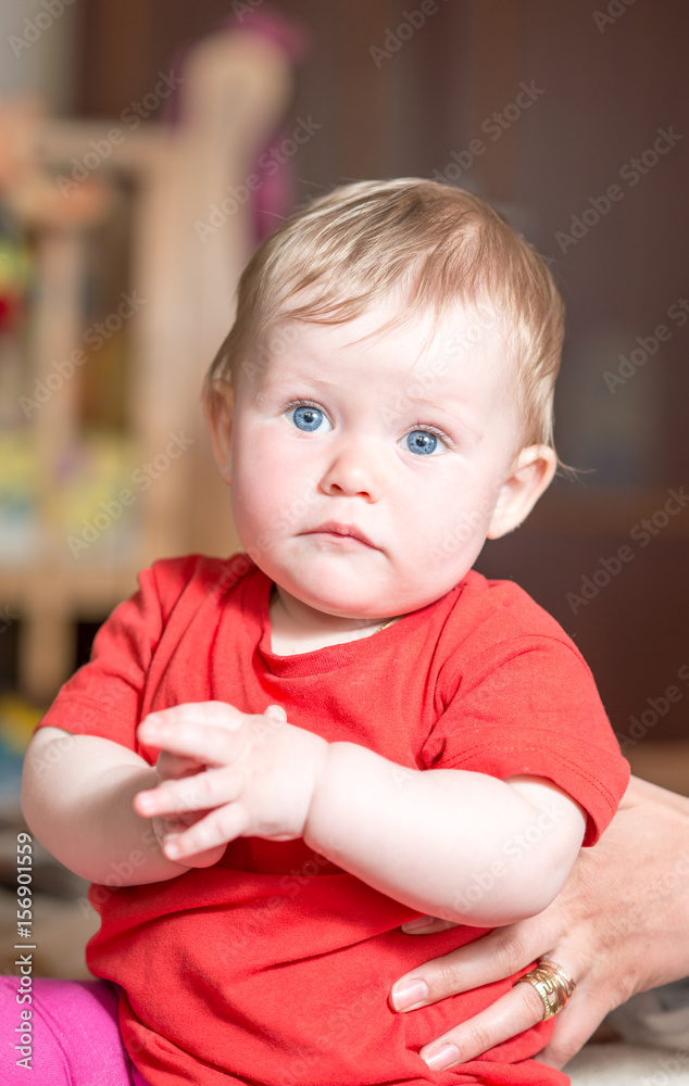 A baby child with blue eyes looks at the camera A baby child with blue eyes looks at the camera