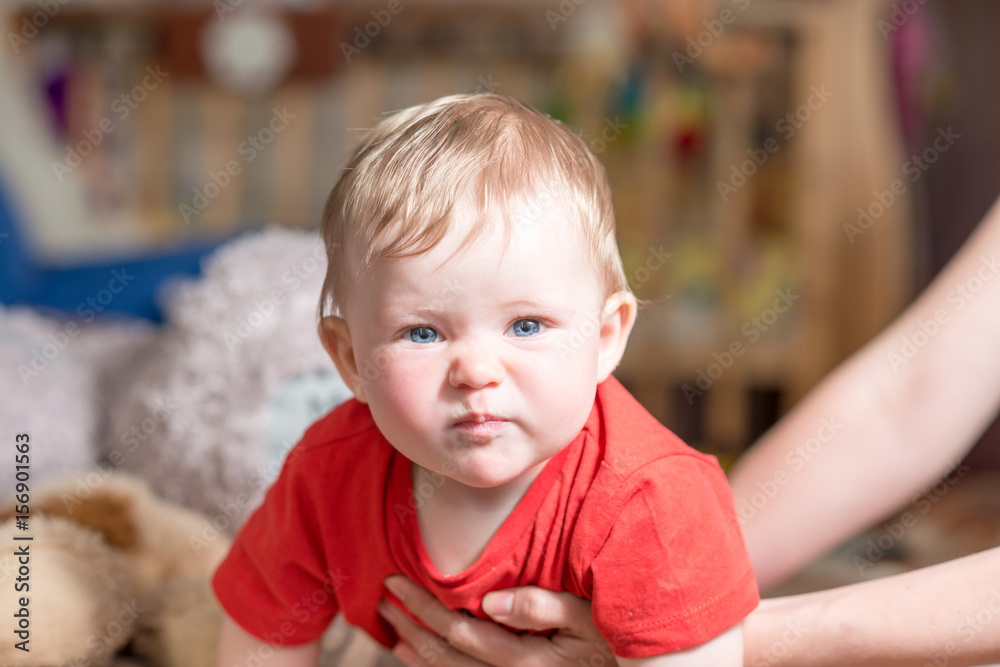 A baby child with blue eyes looks at the camera A baby child with blue eyes looks at the camera