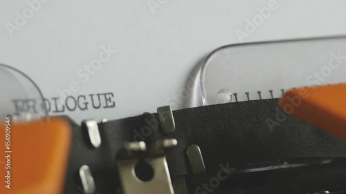 Close up footage of a person writing PROLOGUE on an old typewriter, with sound...