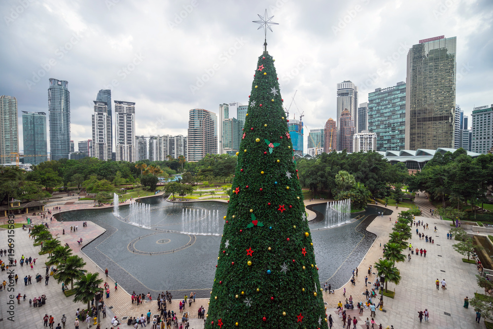 Fototapeta premium Green giant Christmas tree at front of Kuala Lumpur City Centre mall as part of Christmas celebration for downtown Kuala Lumpur.