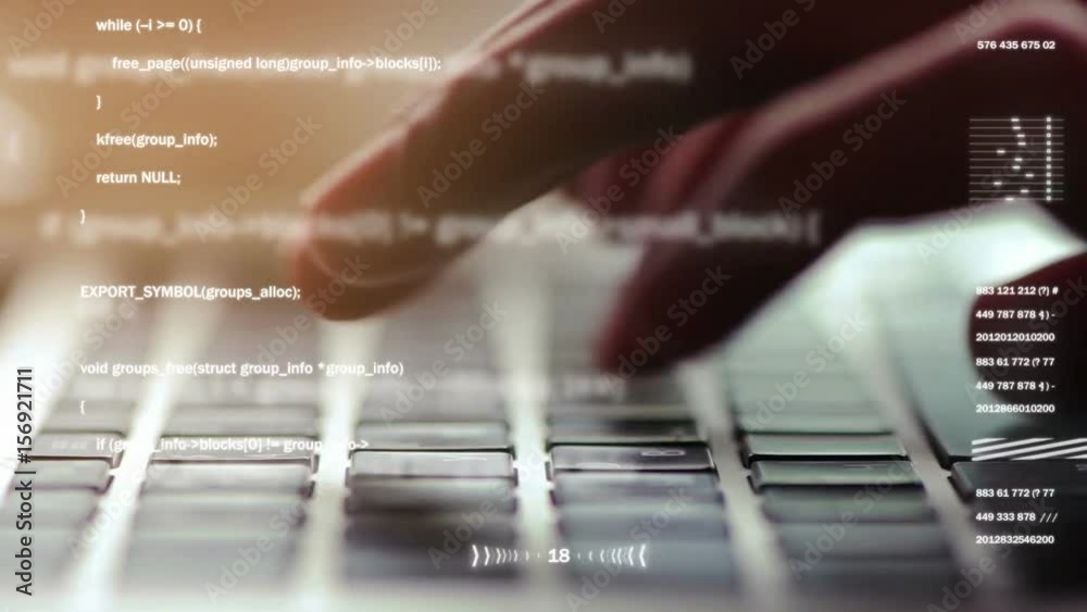 Extreme close-up of human hands typing on laptop keyboard, selective focus