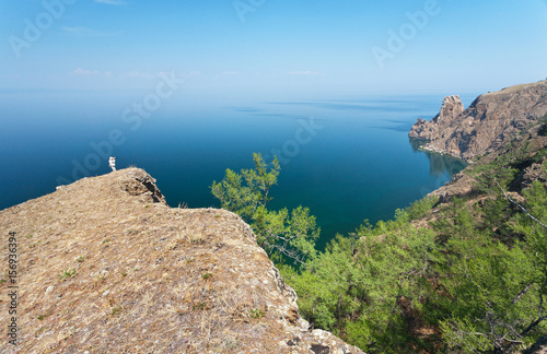 Lake Baikal. Olkhon Island. The tourist photographs Cape Khoboy on a summer day