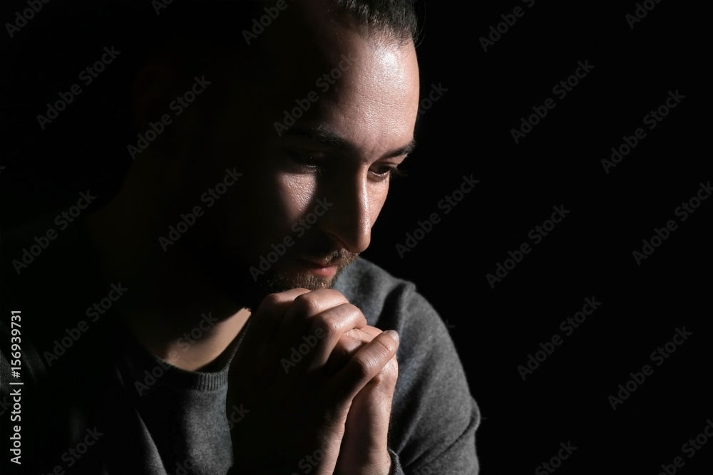 Handsome depressed man on black background Handsome depressed man on black background
