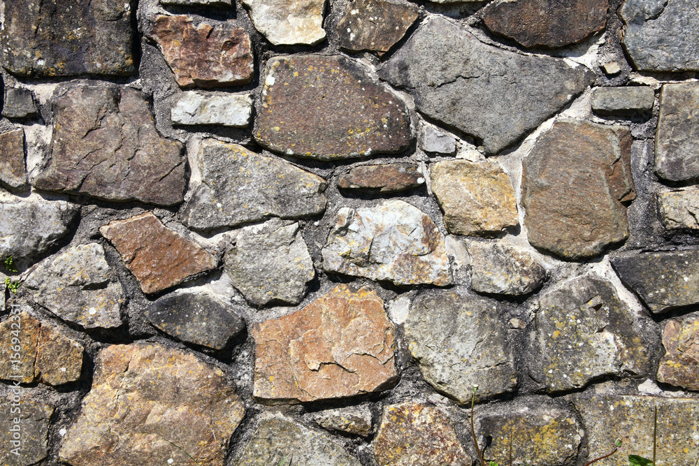 Old weathered rustic stone wall background Old weathered rustic stone wall background
