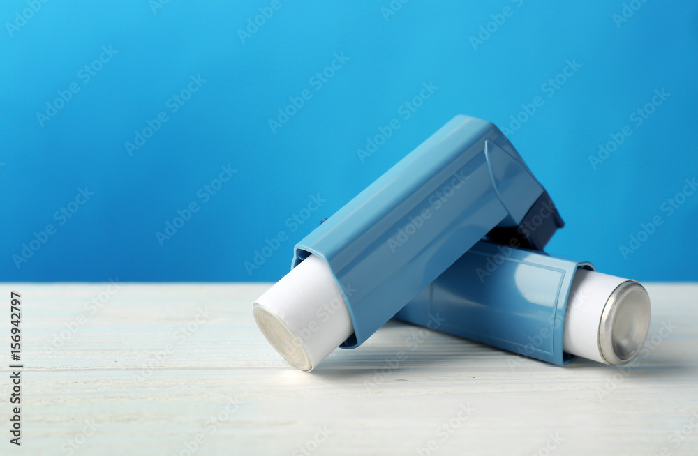 Asthma inhalers on blue background Asthma inhalers on blue background