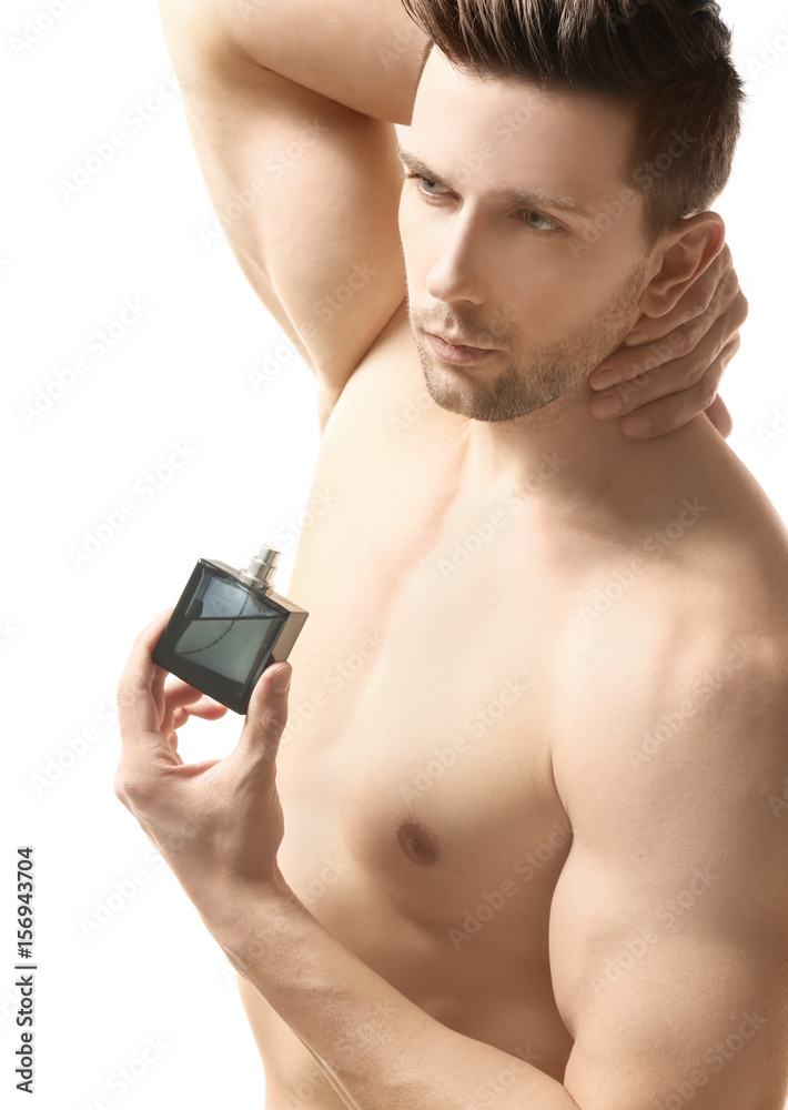 Handsome man using perfume on white background Handsome man using perfume on white background